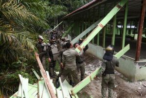 Indonesian civil service police members demolish a church at the Siompin village in Aceh Singkil, Aceh province