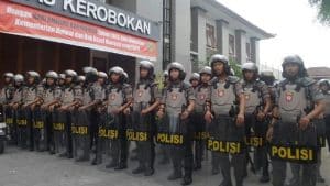 Clashes ... the police riot squad at Kerobokan prison to quash the violence.